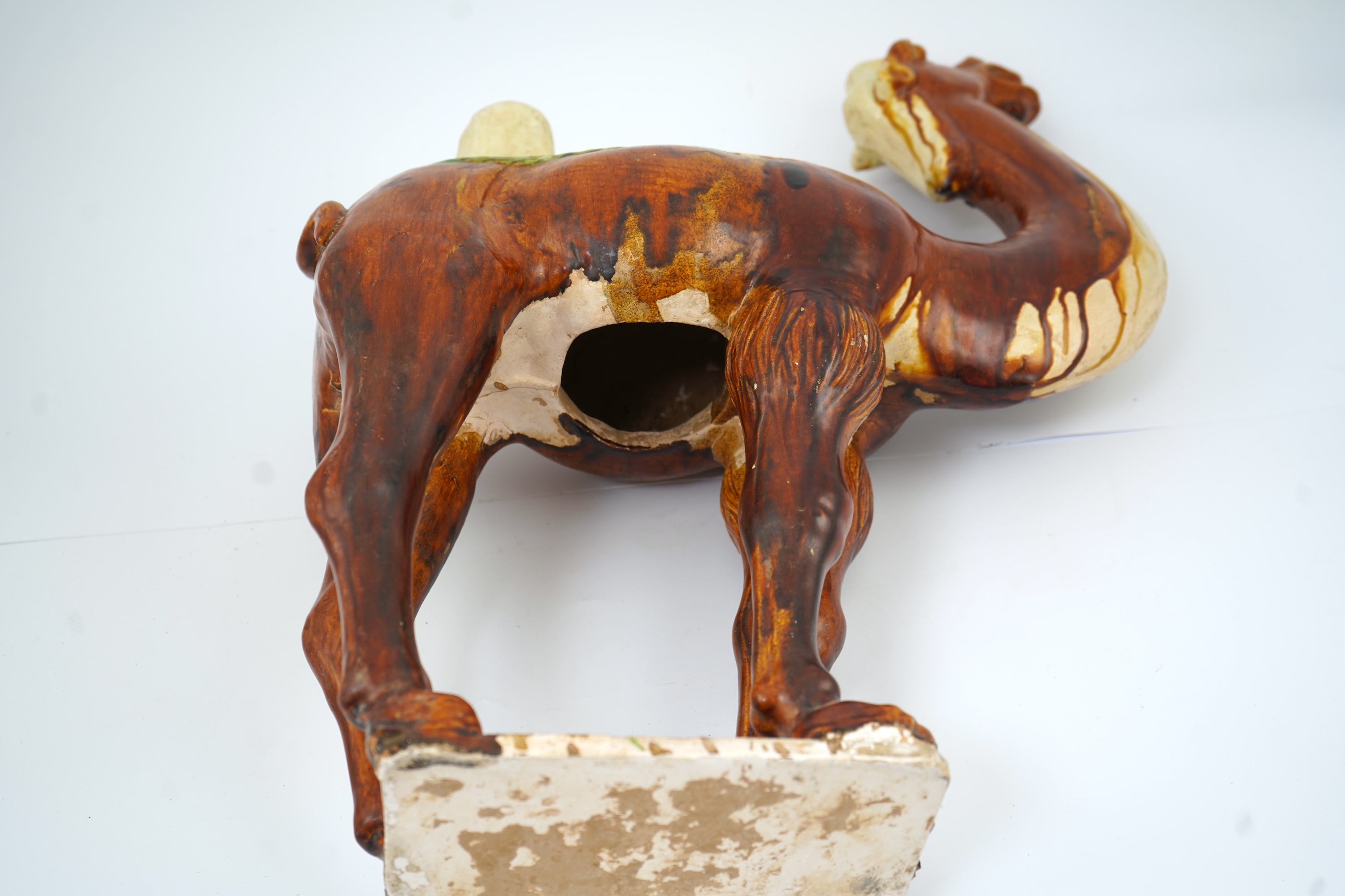 A large Chinese sancai pottery figure of a bactrian camel, Tang dynasty